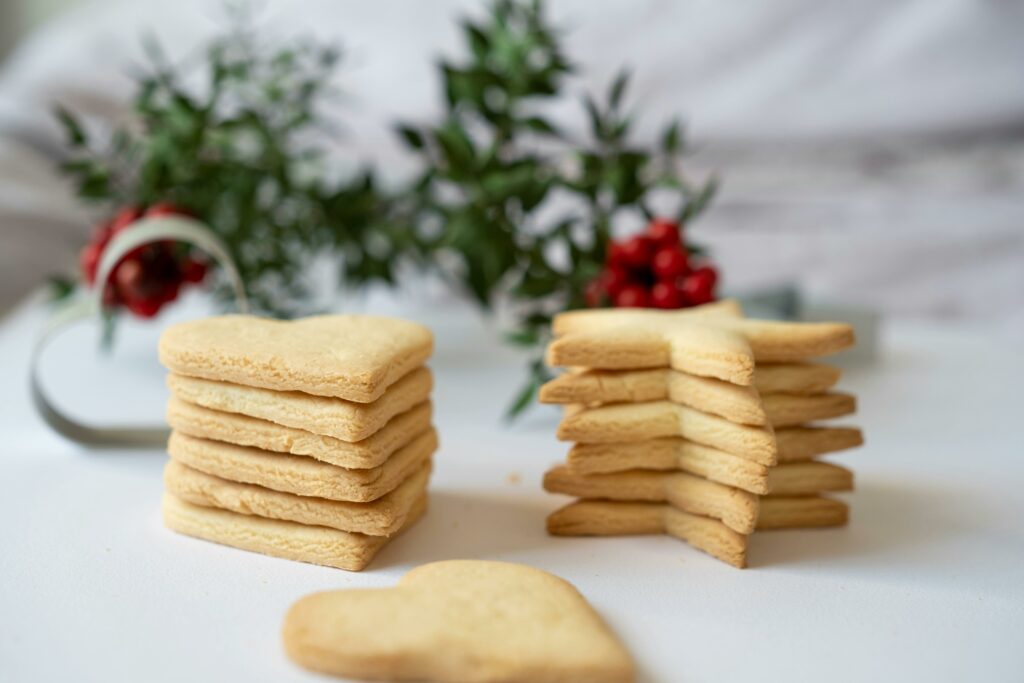 pexels-photo-19573098-19573098 Heart and star-shaped cookies on a white table, perfect for festive holiday treats.
